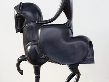Sculpture of stylized figure on horseback.