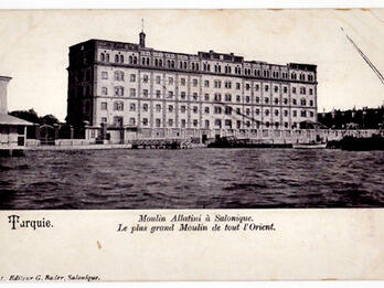 Large symmetrical, rectangular building next to body of water.