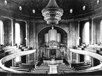 Mainz Synagogue (Organ and Floorplan) Photograph depicting organ and circular rows of benches, with large central chandelier.