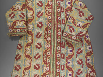 Coat embroidered with flowers, vines, and geometric patterns.