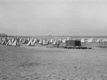 Photograph of many tents in a field. 