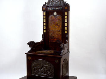 Elijah’s Chair Wood chair inscribed with figures.