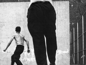 Handball Players, Houston Street, NY Photograph of two men playing handball, both of whom are turned away from the viewer and facing the wall.