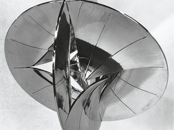 Spherical polished aluminum sculpture resembling two intersecting discs. 