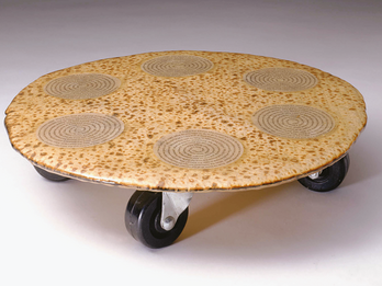 Seder Plate: Untitled Matzah and paper in epoxy resin on wheels with six spirals made of typeset text on top of matzah.