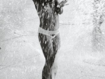 Photograph of child playing in fountain.