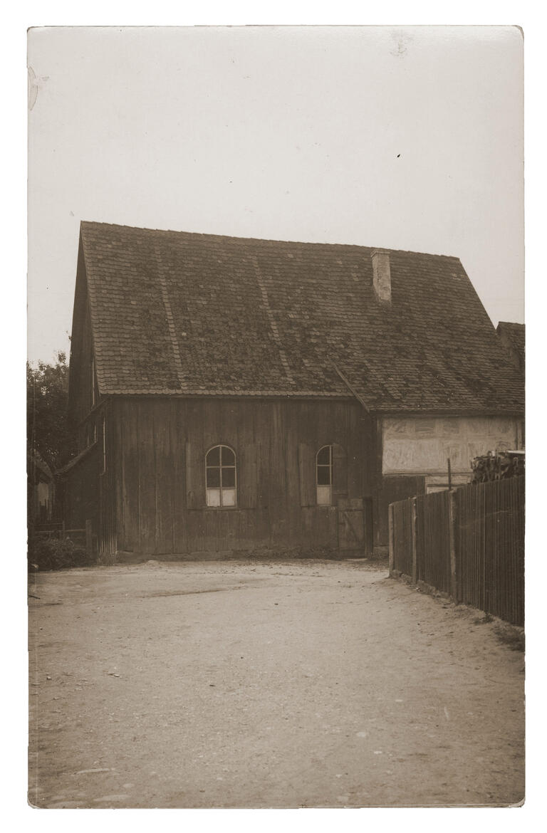 Synagogue, Bechhofen, Germany Exterior view of wooden building with dirt path.