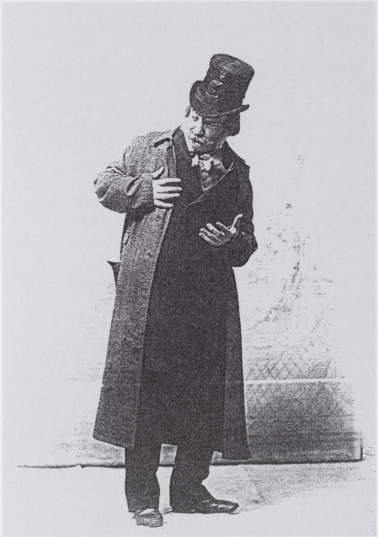 Photograph of man in top hat looking off to the side.