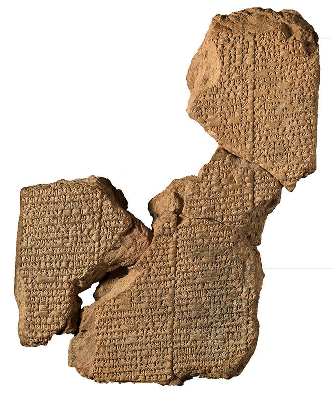 Clay tablet in several sections inscribed with Akkadian text.