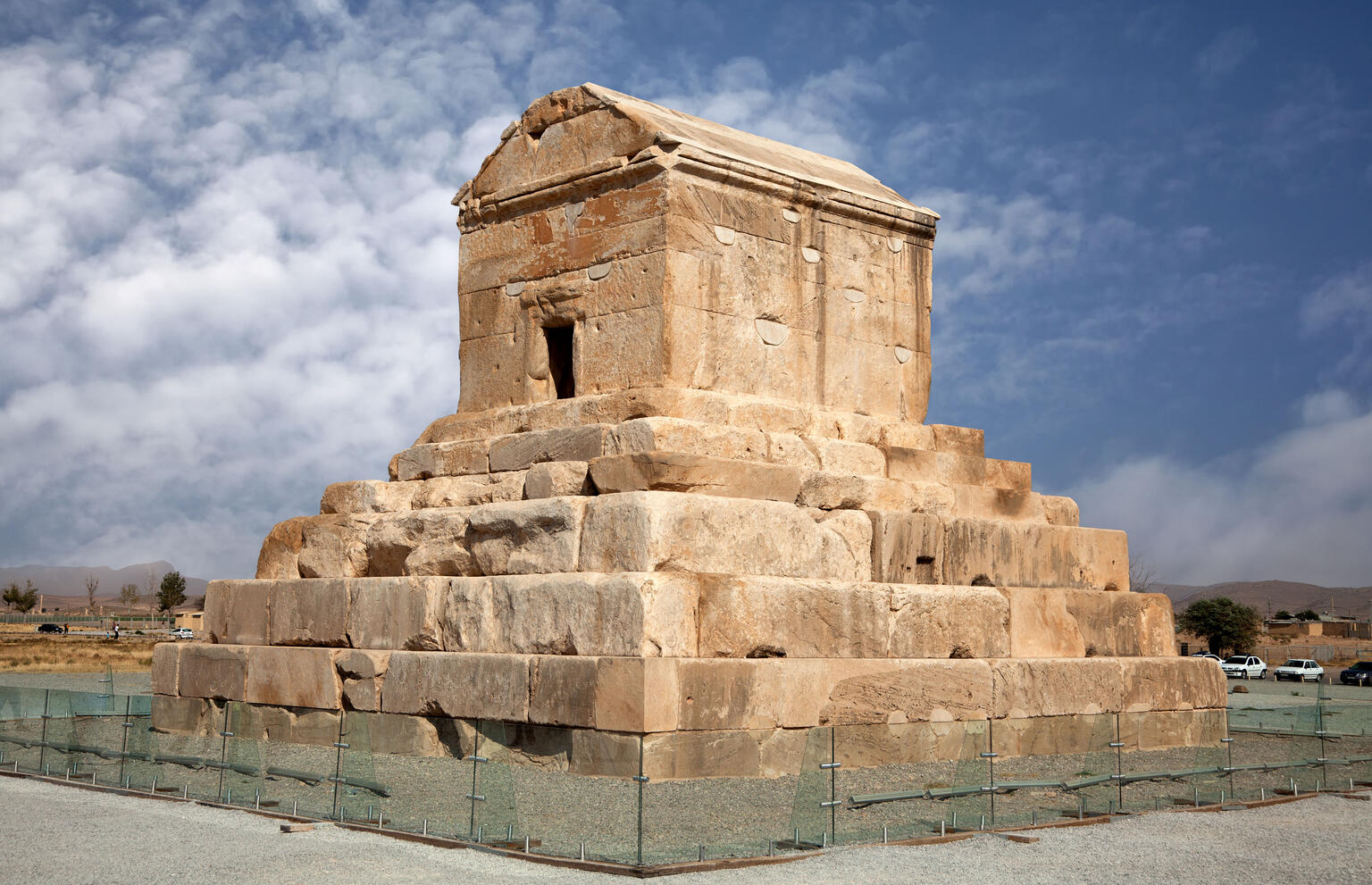 Photograph of stone tomb on top of tiered platform. 