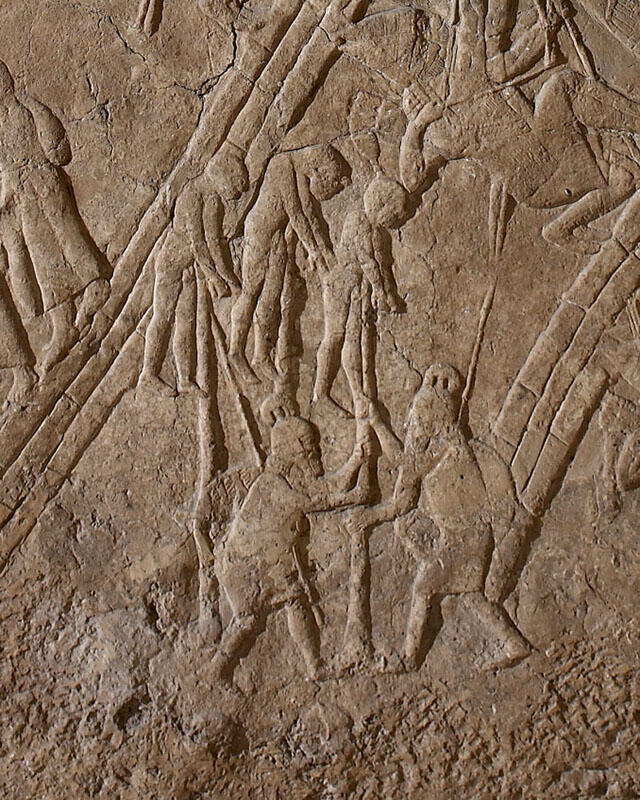 Relief of two people impaling three people. 