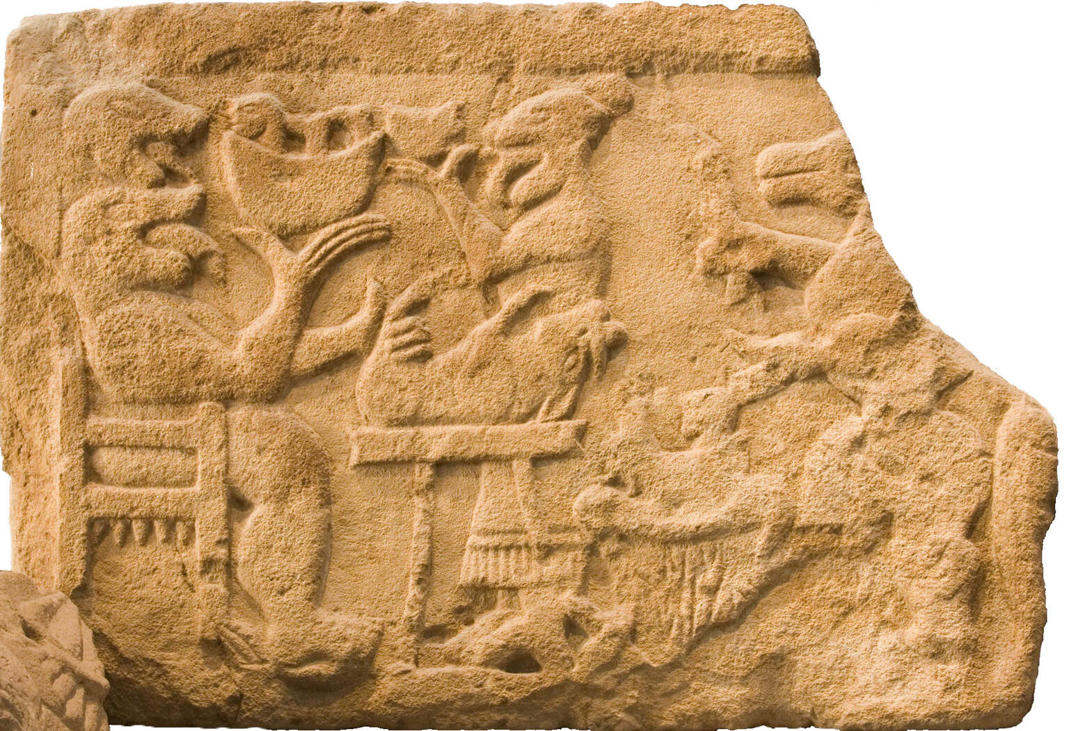 Stone relief of human-like monster in a chair and several animals and figures. Stone relief of human-like monster in a chair and several animals and figures.