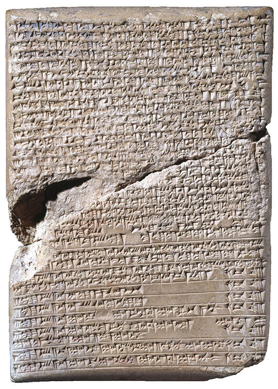 Stone tablet with large crack in middle inscribed with Akkadian writing.