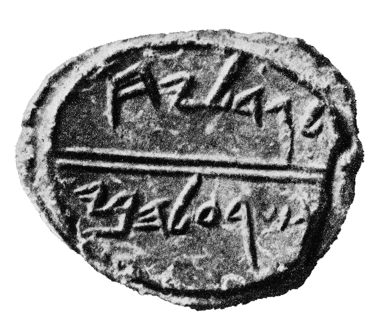 Round clay piece inscribed with Hebrew.