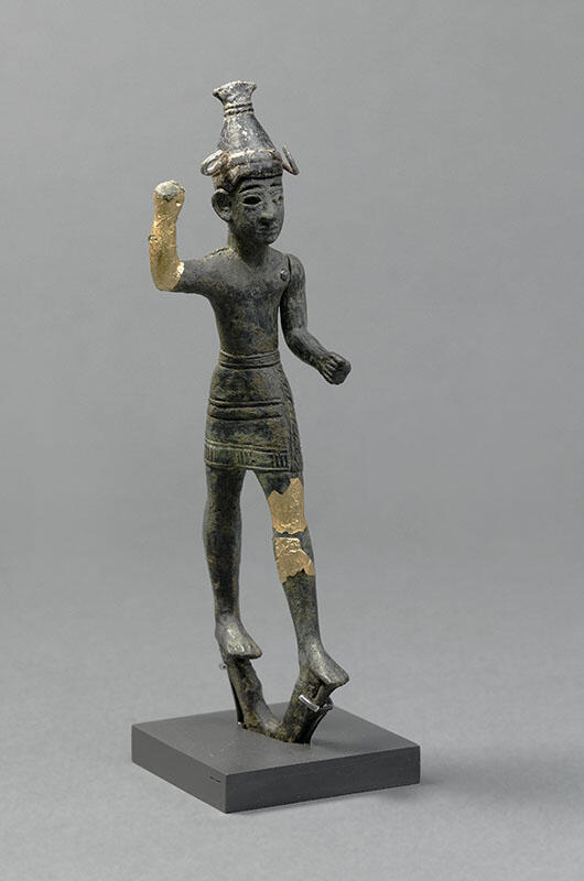 Figurine with horned helmet and raised hand, with gilded bronze on hand and thigh.