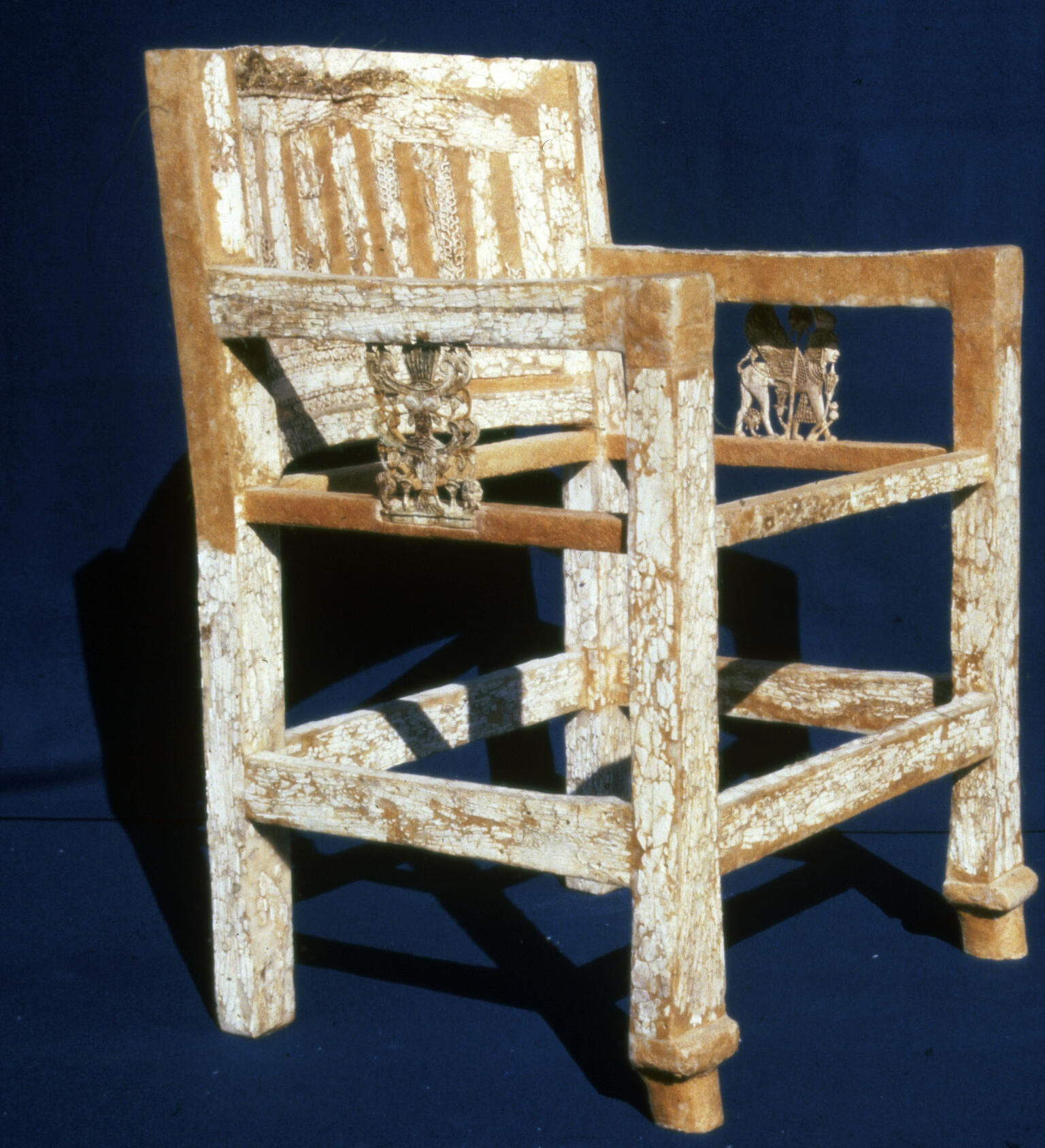 Armed chair decorated with ivory inlay including elaborate carving on arms.