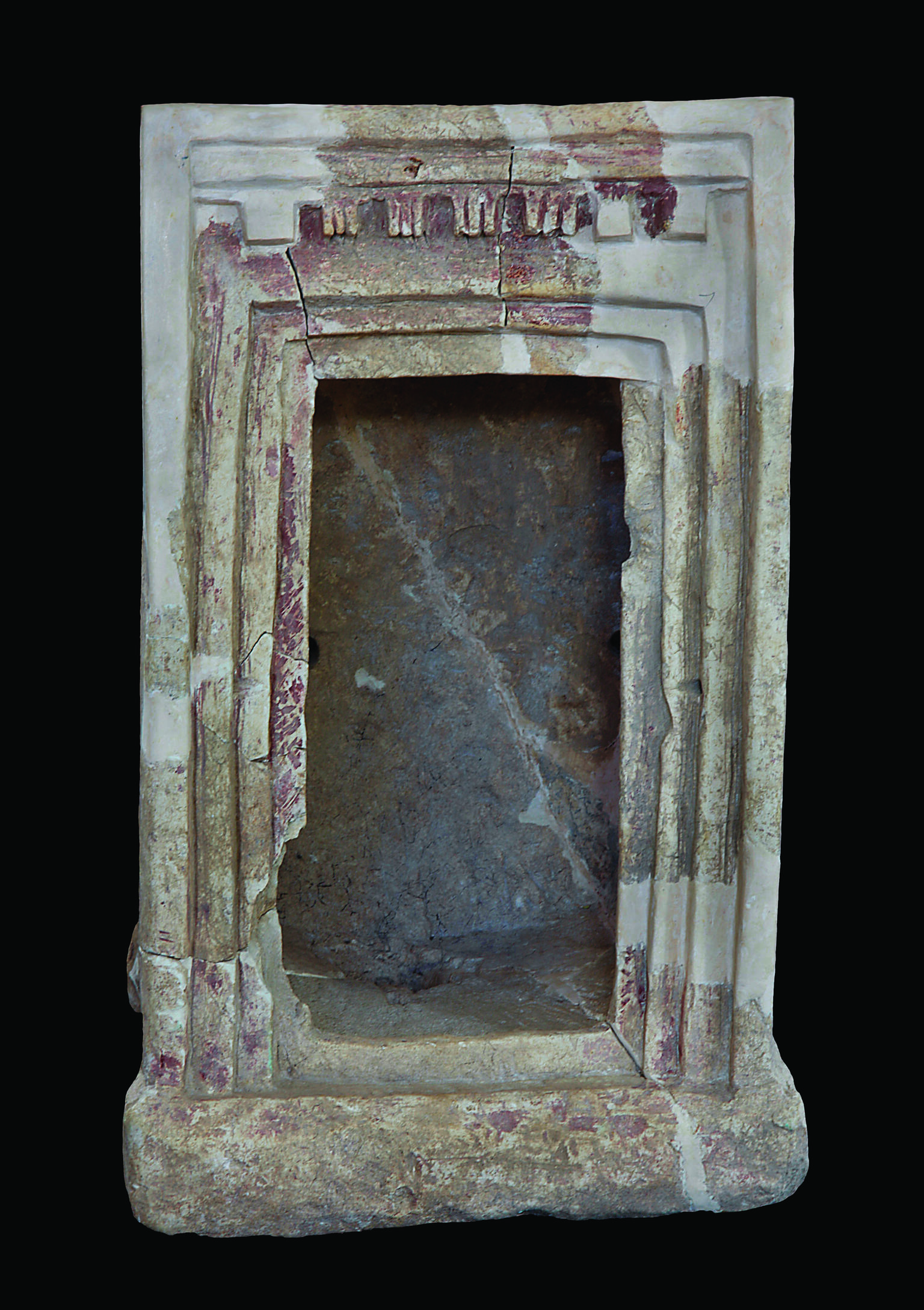 Terra-cotta shrine with capitals at entrance.