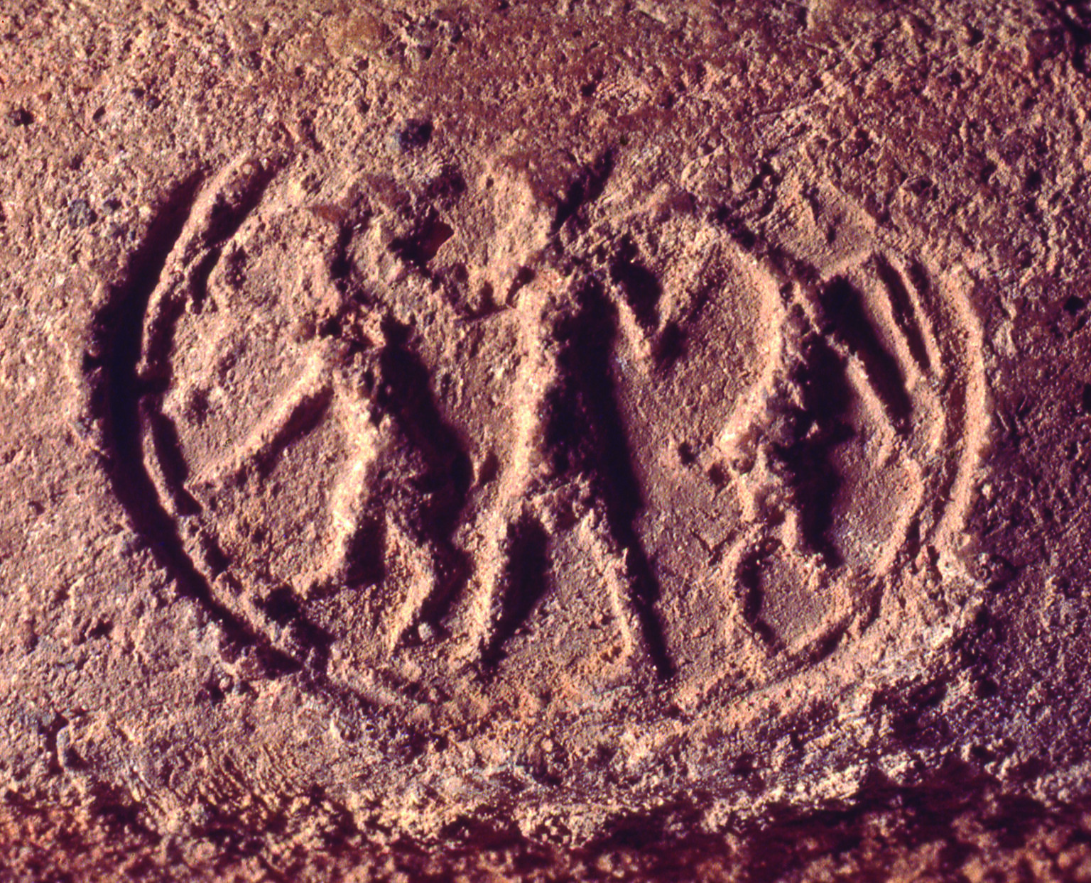 Seal impression with figure holding two ibex-like animals. Seal impression with figure holding two ibex-like animals.