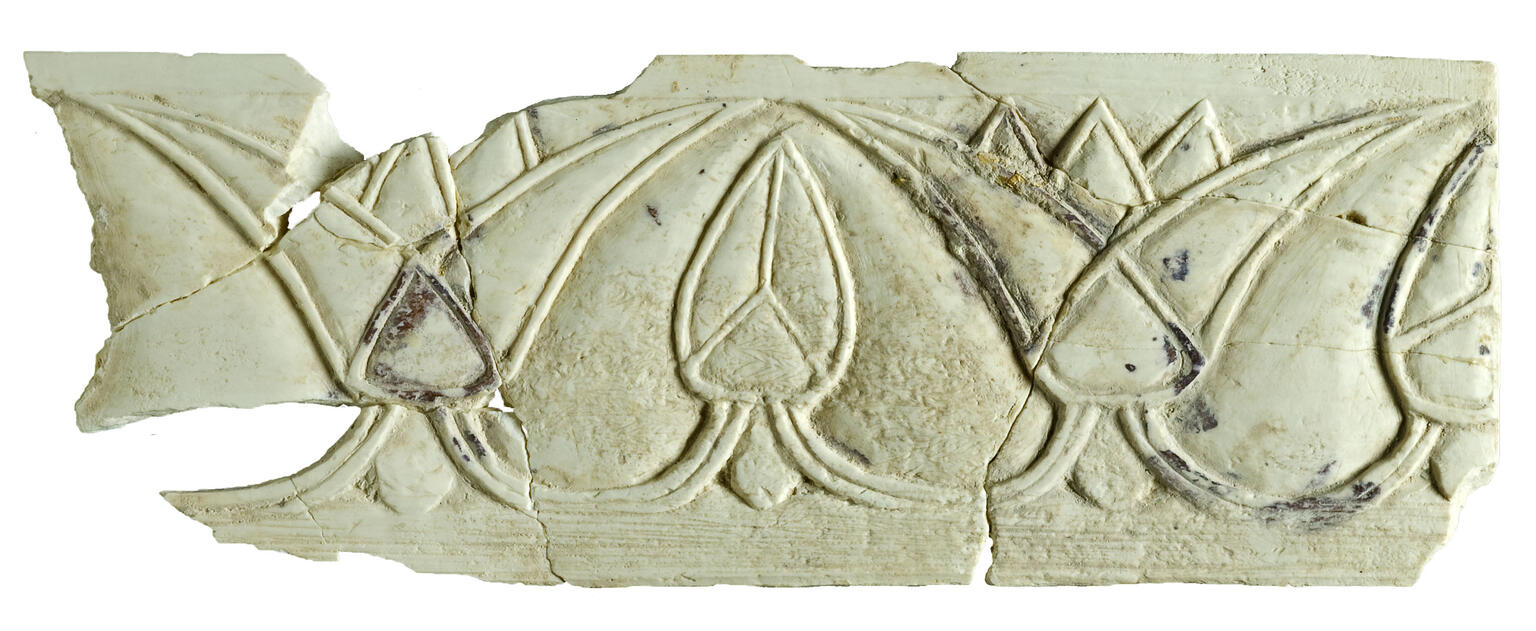 Ivory carving of a horizontal series of lotus flowers with alternating open and closed buds.