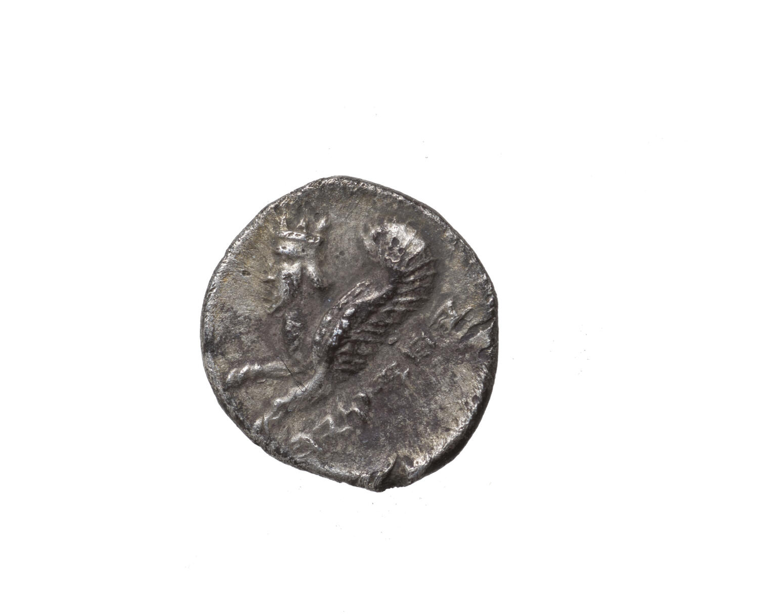 Coin with image of winged creature with human head, beard, and horns and Hebrew inscription.