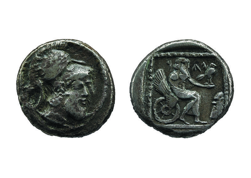 Front of coin depicting head with beard wearing helmet and back of coin depicting figure on winged chariot holding bird.