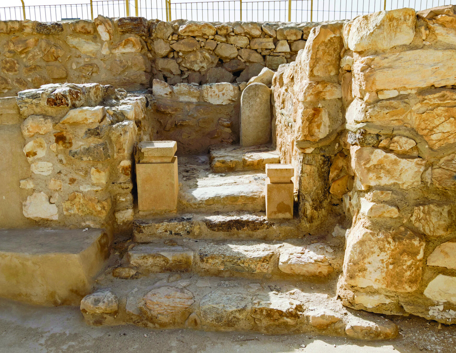 Photograph of remains of stone structure with steps and two small altars.