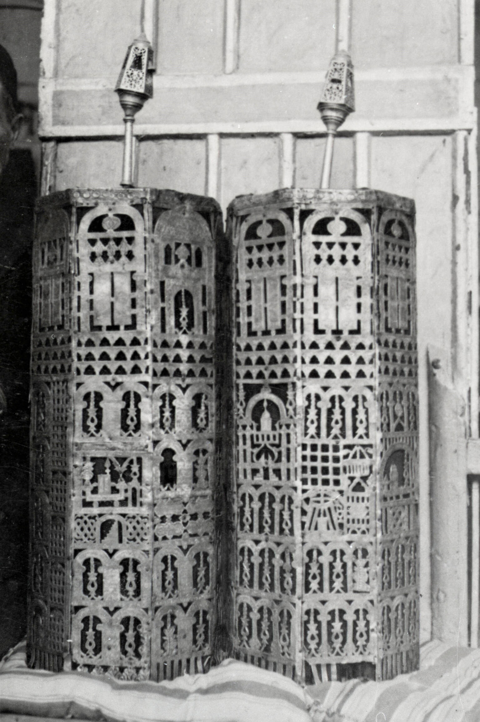 Cylindrical cases carved with geometric designs. Cylindrical cases carved with geometric designs.