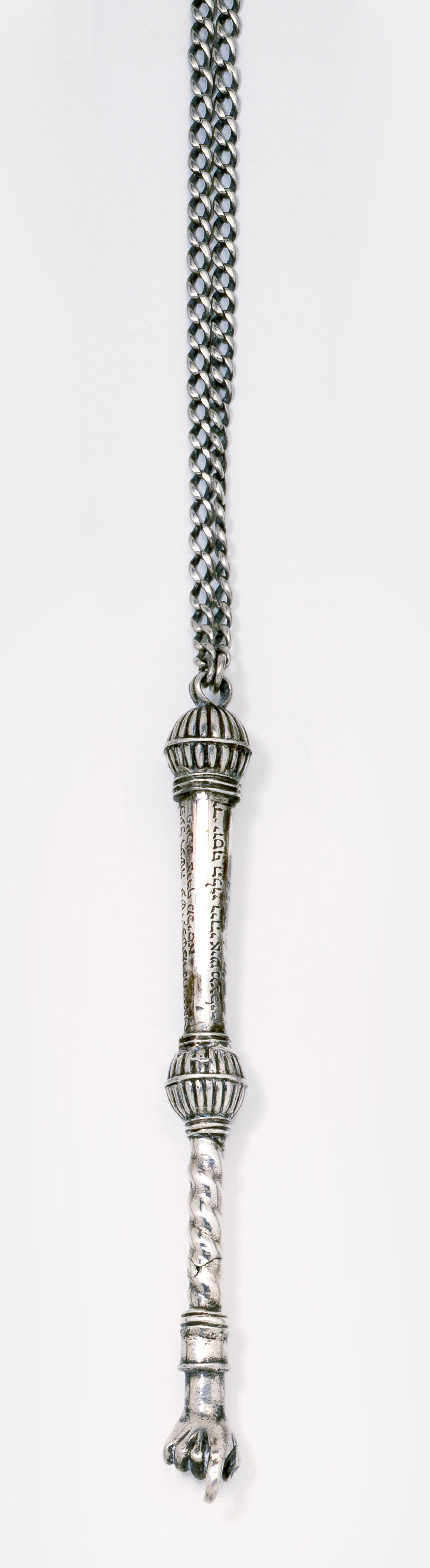 Object with hook and Hebrew imprinted along decorative handle. 