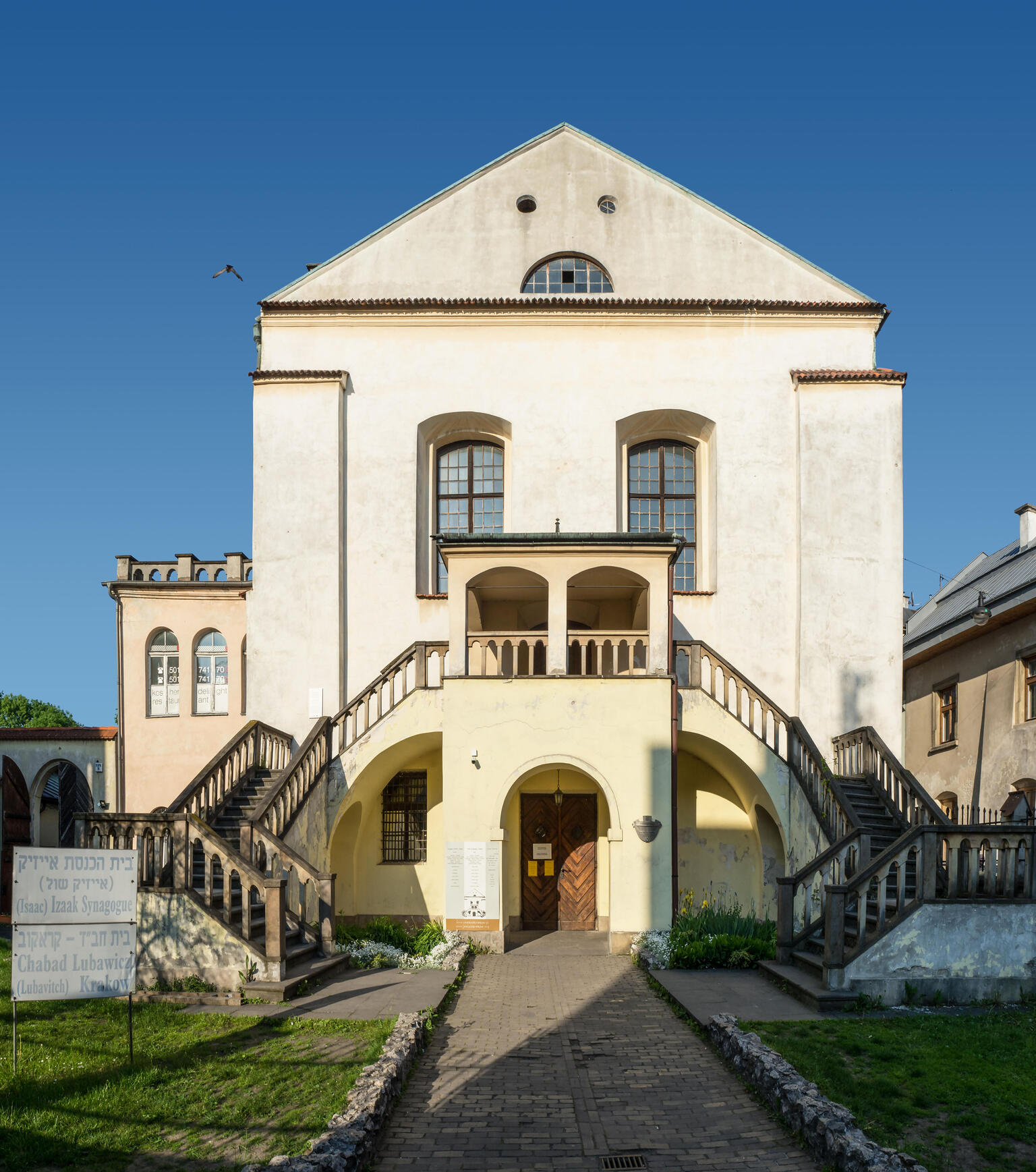 Photograph of exterior of stone building with double staircase.