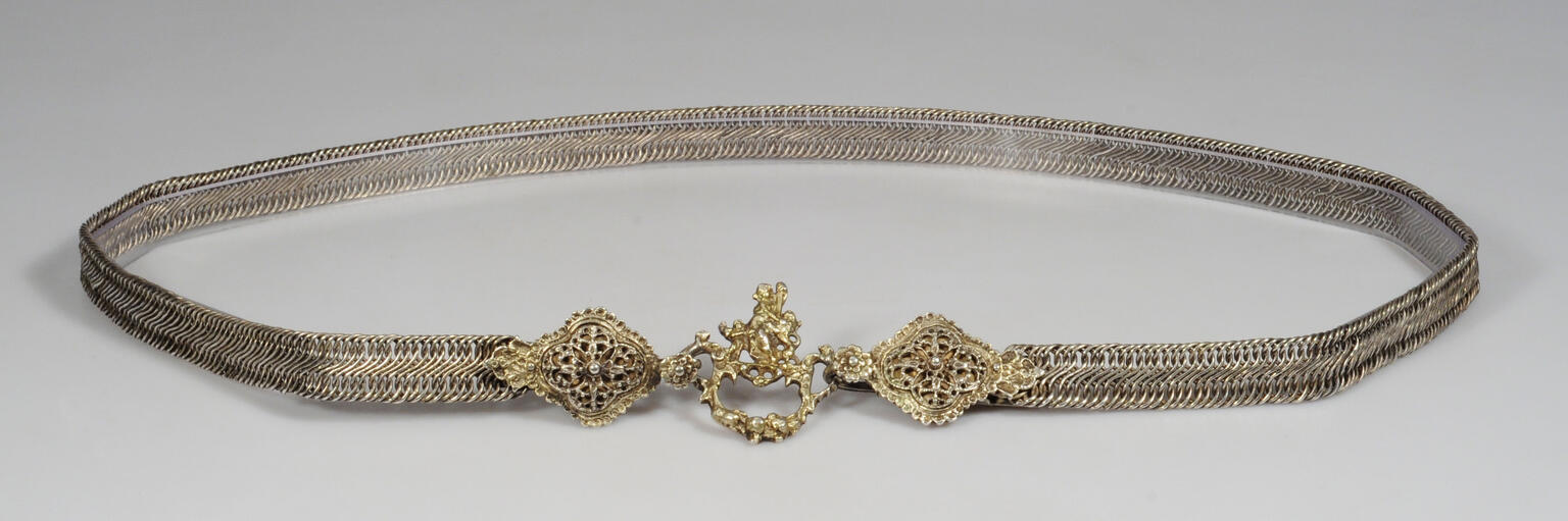 Metal belt with carved clasp.