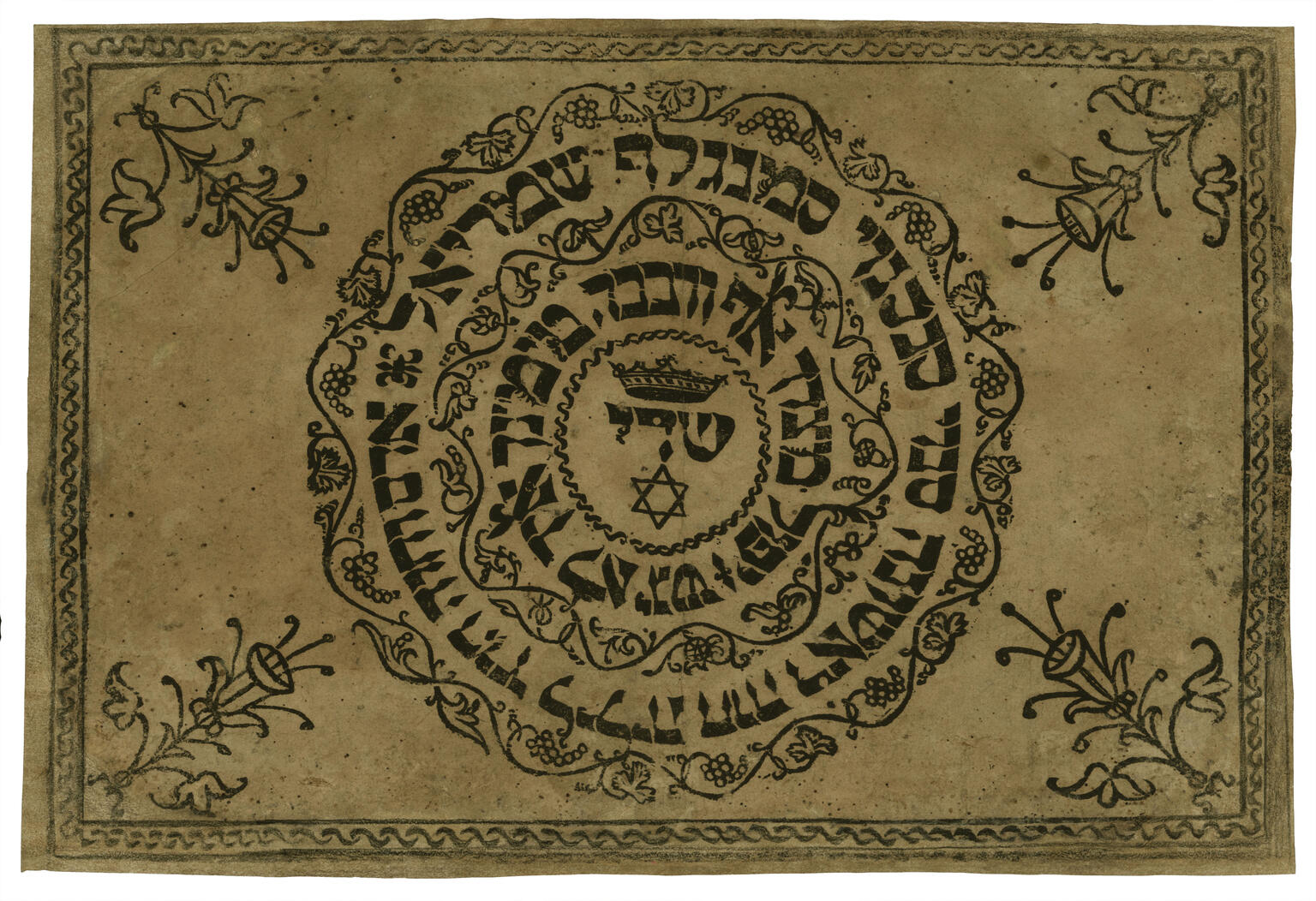 Printed page with Hebrew text in a circle framed by decorative motif with flower in each corner.