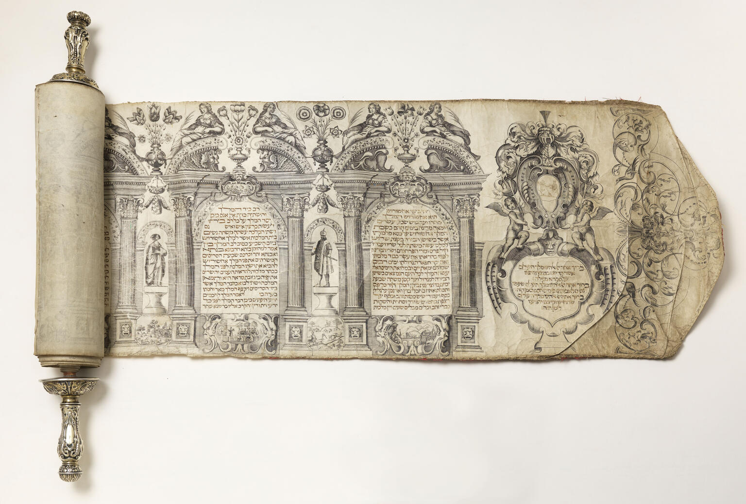 Beginning of scroll with Hebrew text arranged in columned archways and decorated figures above and beside each column. Beginning of scroll with Hebrew text arranged in columned archways and decorated figures above and beside each column.