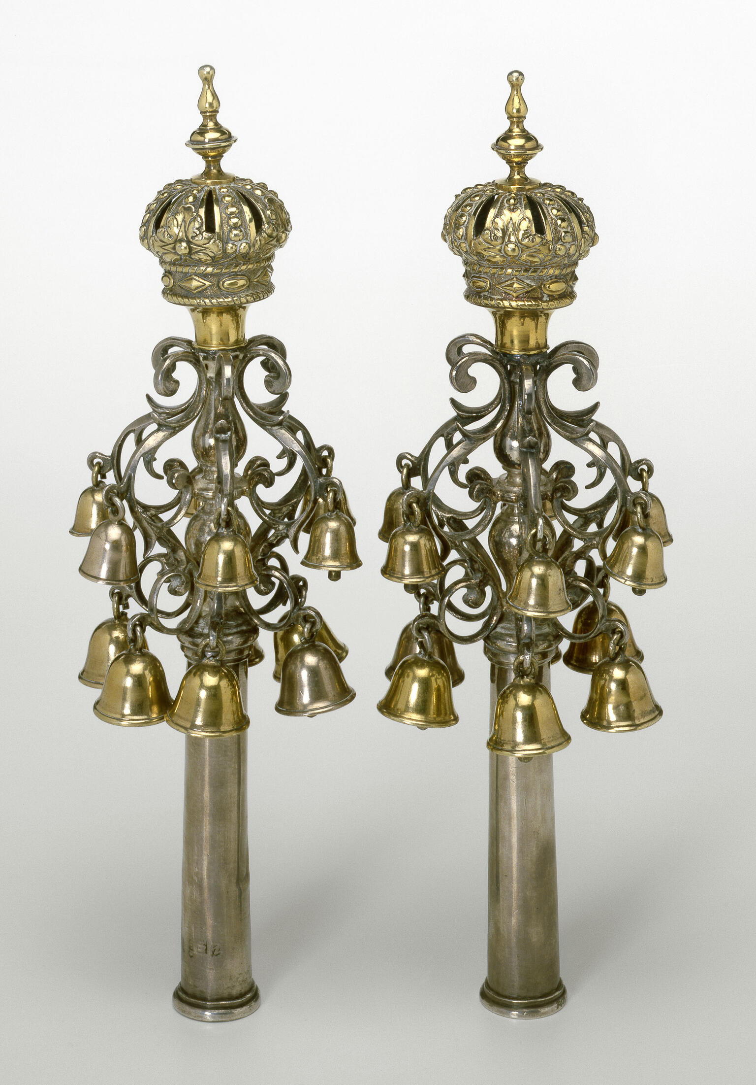 Pair of finials with crowns of bells on branches. Pair of finials with crowns of bells on branches.