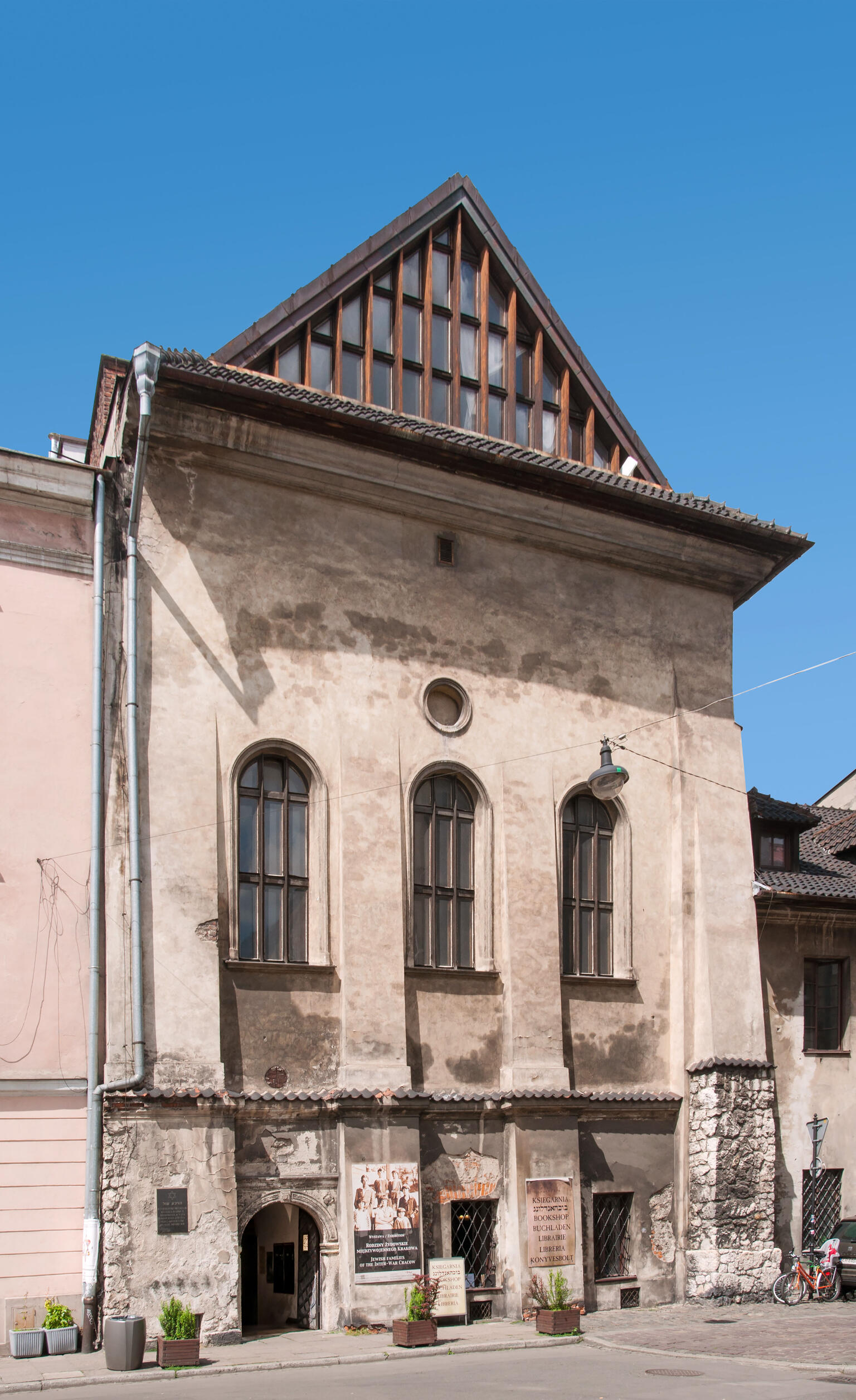 Exterior photograph of building with arched windows and triangular room.  