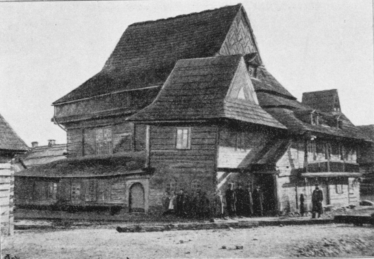 Exterior photograph of wooden building with shingles. Exterior photograph of wooden building with shingles.