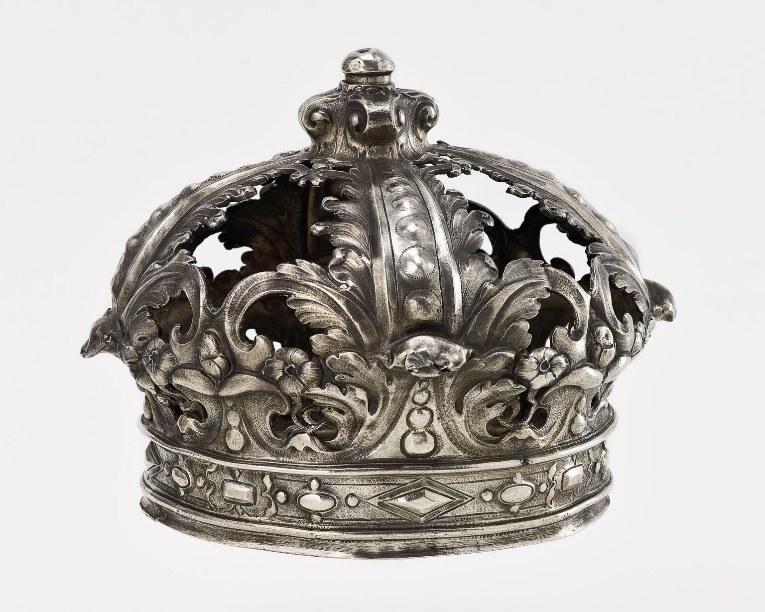 Crown with punched and engraved leaves, vines, and jewels. Crown with punched and engraved leaves, vines, and jewels.