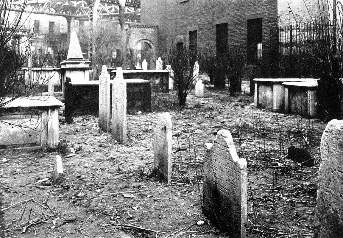 Photograph of headstones in cemetery. 