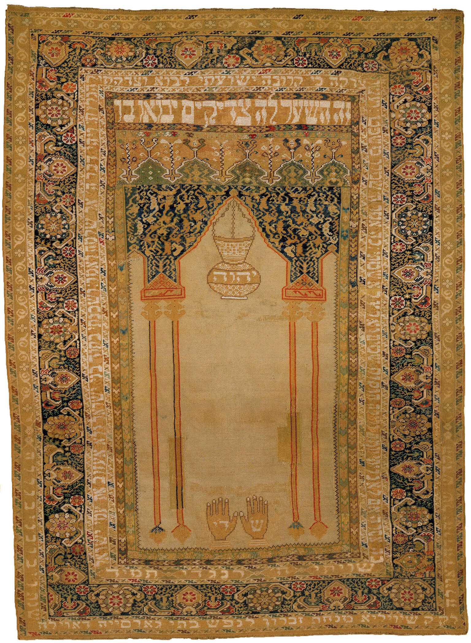 Textile with woven image of two hands at bottom beneath censer and decorative borders. 