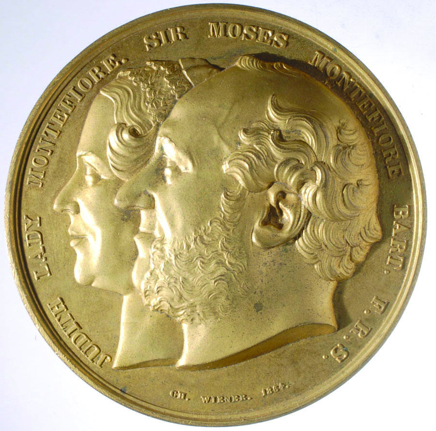 Medal featuring profile portraits of a man and woman. Medal featuring profile portraits of a man and woman.