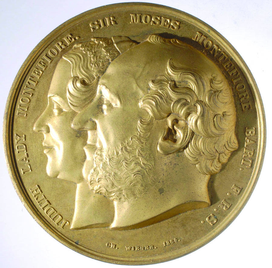 Medal featuring profile portraits of a man and woman.