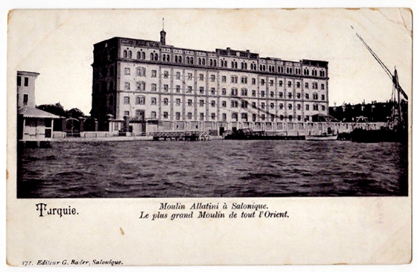 Large symmetrical, rectangular building next to body of water.