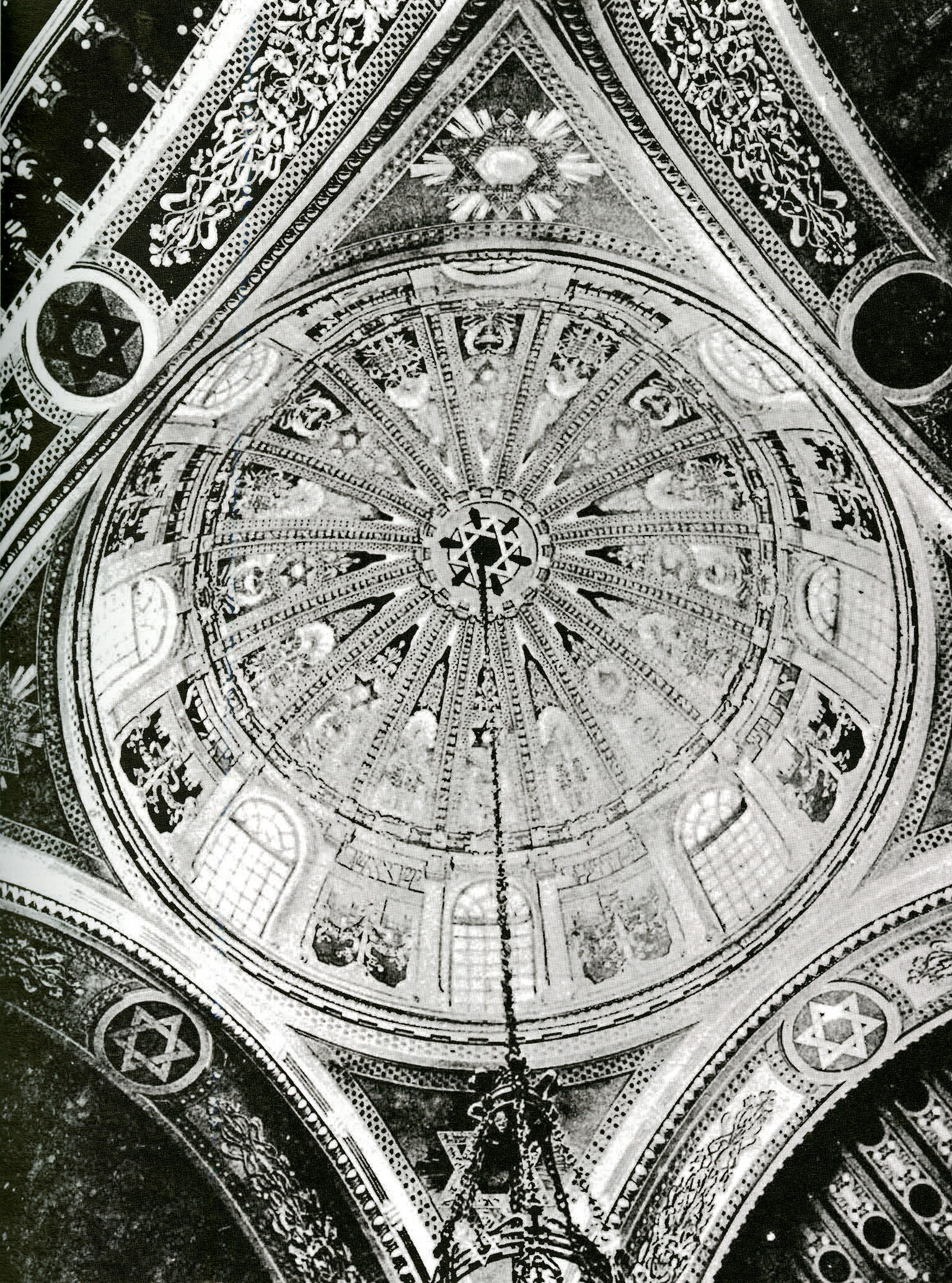 Photograph of domed ceiling covered with geometric shapes, including Stars of David.