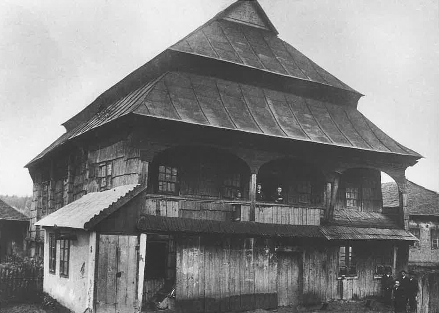 Photograph of wooden building with tiered triangular roof.