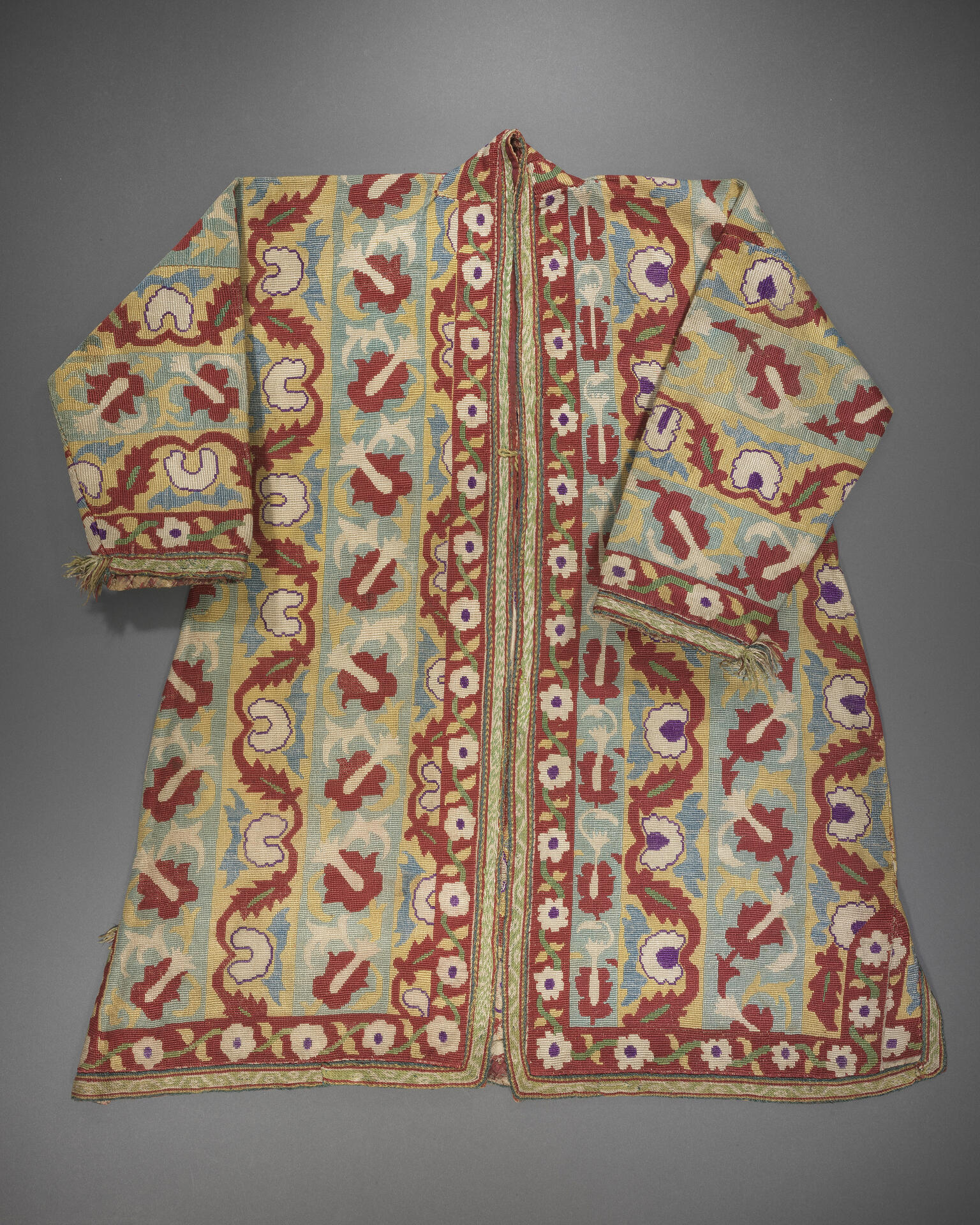 Coat embroidered with flowers, vines, and geometric patterns. Coat embroidered with flowers, vines, and geometric patterns.