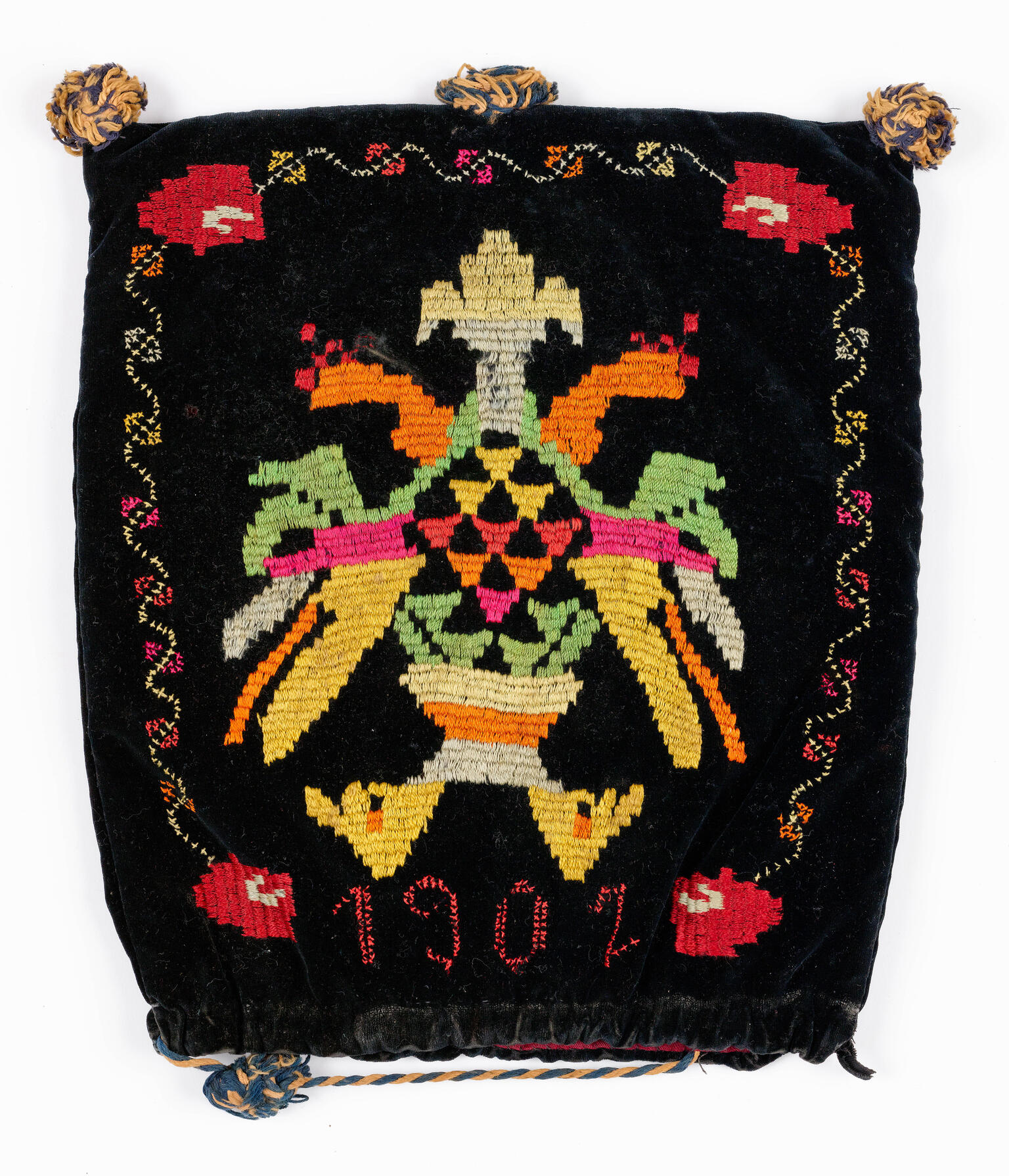 Velvet tefillin bag with embroidered date and a double-headed eagle.