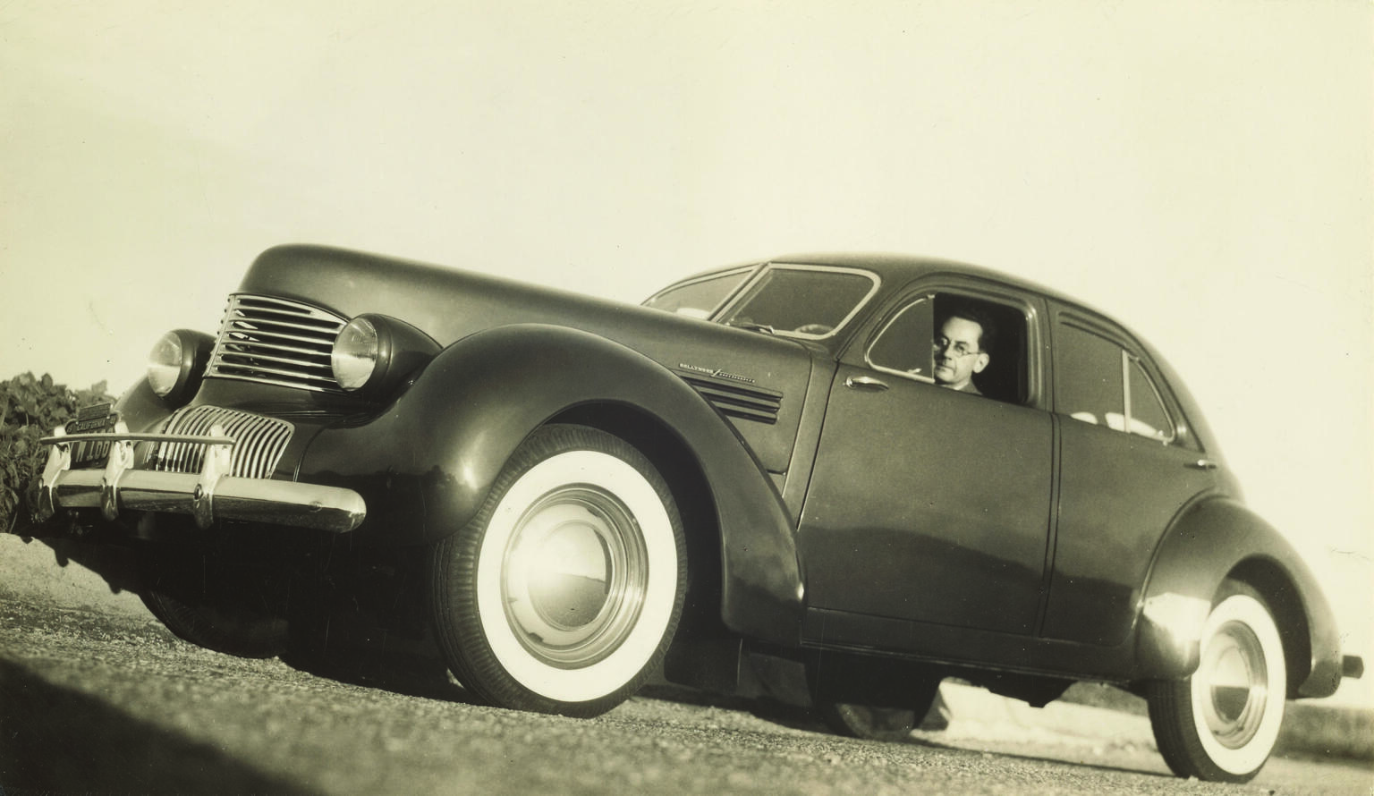 Low angle photograph of a man inside a car. 