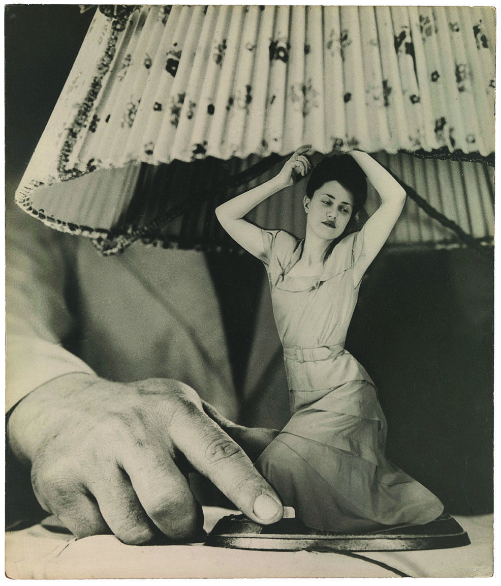 Photomontage featuring male hand grabbing the base of a lamp. The lamp base is a woman wearing a dress.