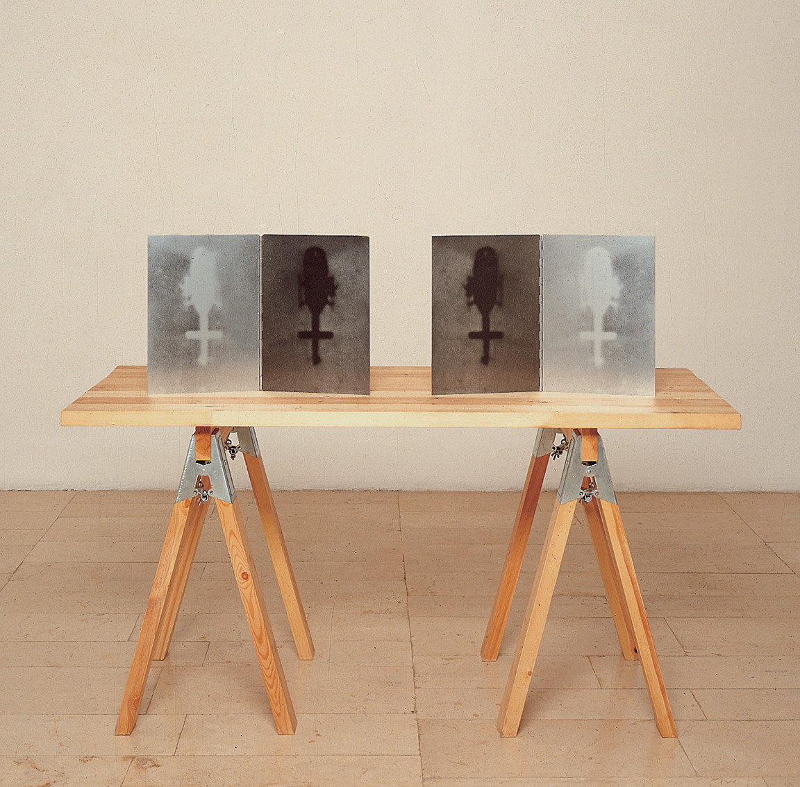 Sawhorse table with four images of a helicopter from a bird's-eye view propped up on it. Sawhorse table with four images of a helicopter from a bird's-eye view propped up on it.