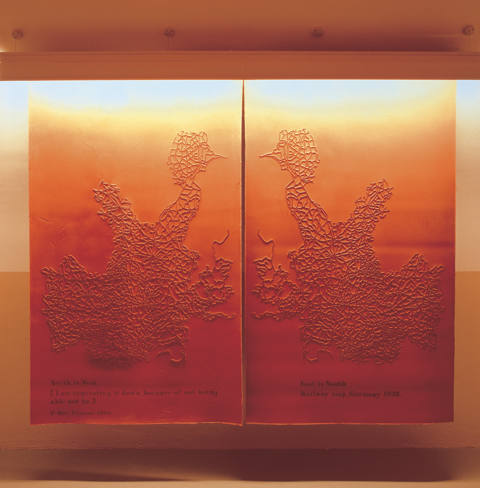 Two side-by-side maps made of neon lights and rubber.