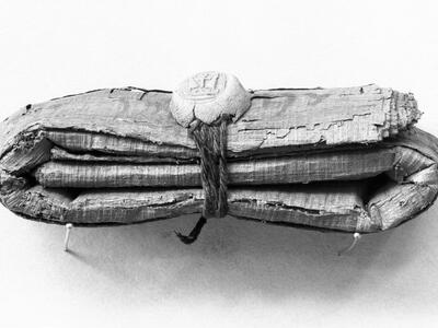Bundle of folded papyrus tied with string and seal.